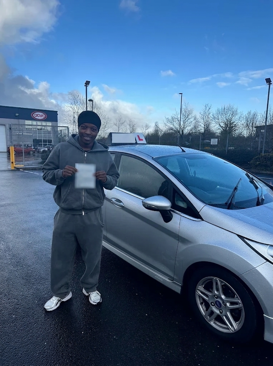 A learner with their pass certificate in front of the Fiesta
