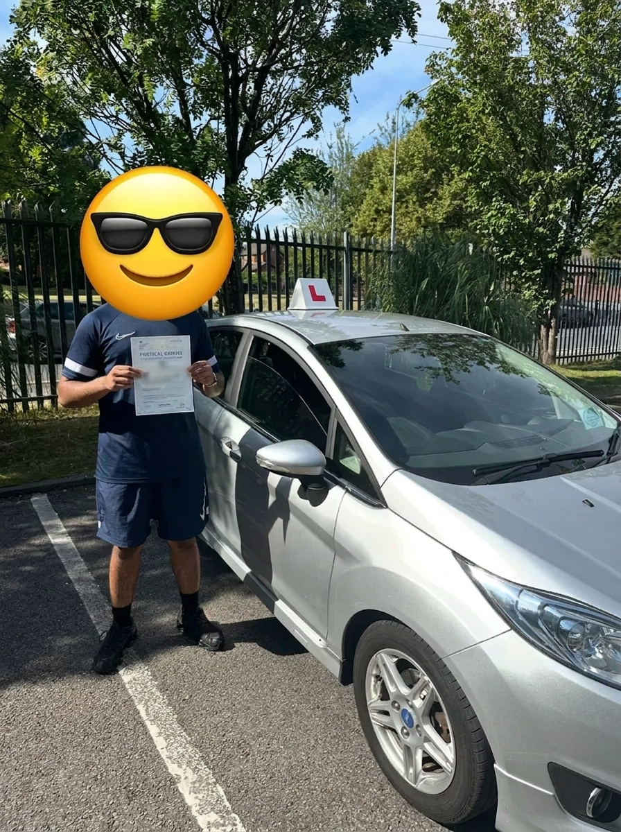 A learner with their pass certificate at the test centre