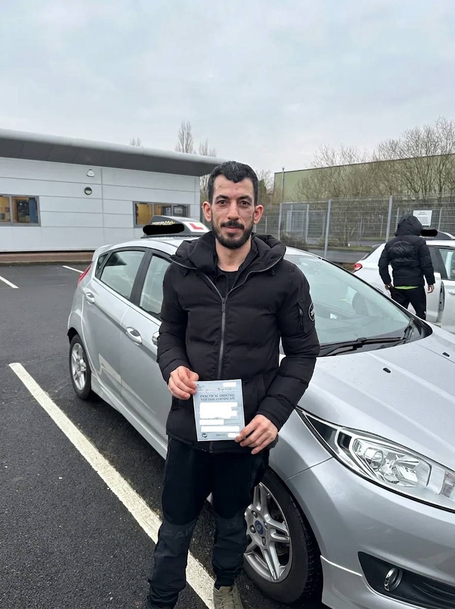 A learner with their pass certificate in front of the Fiesta